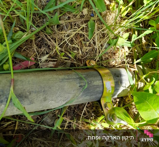 צינור מתכת עם תפסן ברזל על הקרקע